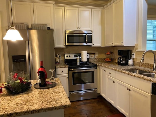 kitchen featuring white cabinetry, light stone countertops, sink, dark wood-type flooring, and appliances with stainless steel finishes