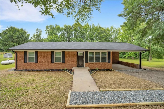 ranch-style home featuring a carport and a front yard