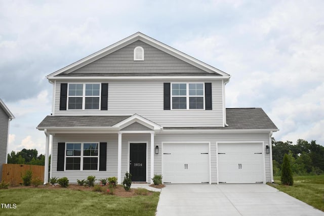 view of front of home featuring a garage and a front yard