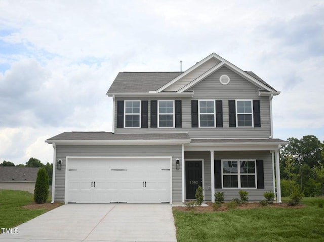 view of front of house featuring a front lawn and a garage