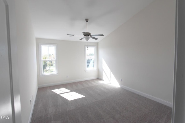 unfurnished room featuring vaulted ceiling, carpet floors, and ceiling fan