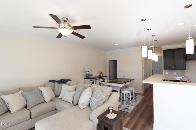 living room featuring crown molding, dark hardwood / wood-style floors, and ceiling fan