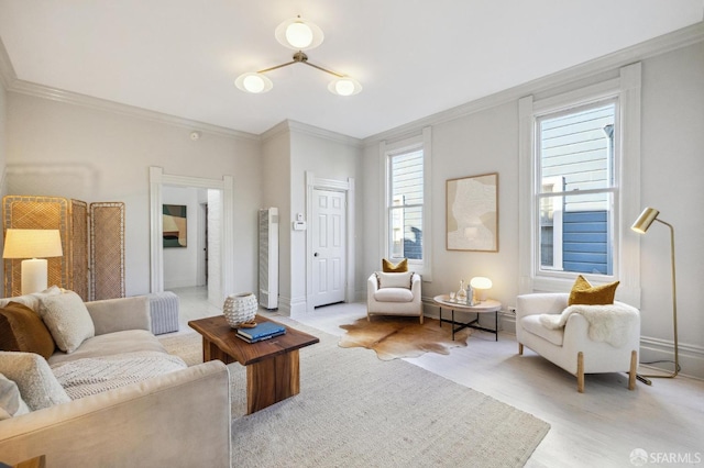 living room featuring crown molding and light hardwood / wood-style flooring