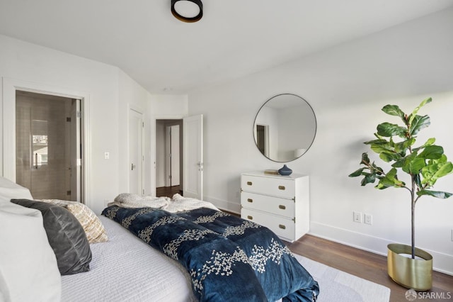 bedroom with dark hardwood / wood-style floors