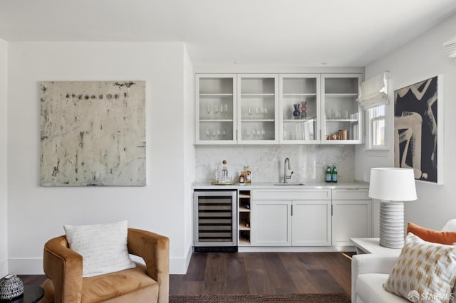 bar with sink, white cabinetry, dark hardwood / wood-style floors, wine cooler, and tasteful backsplash