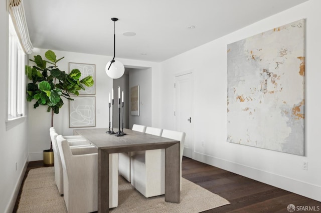 dining space with hardwood / wood-style floors