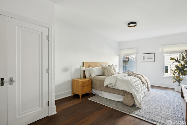 bedroom with a closet and dark hardwood / wood-style floors