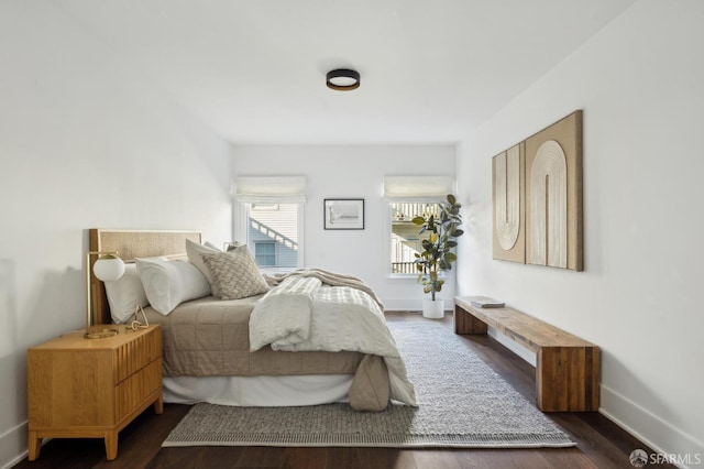 bedroom with dark wood-type flooring