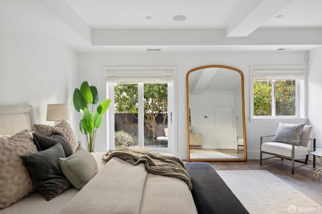 bedroom featuring multiple windows and hardwood / wood-style flooring