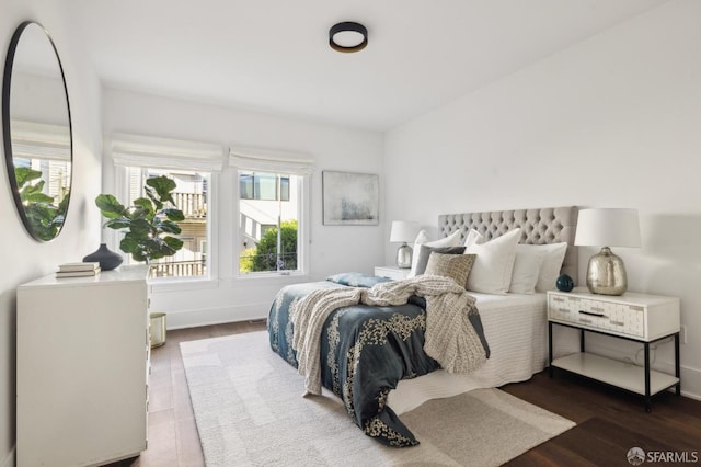 bedroom with dark hardwood / wood-style flooring