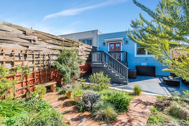 exterior space with stairs, a patio, and fence