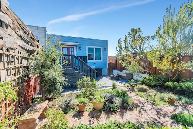 rear view of house featuring outdoor lounge area, a patio area, and a fenced backyard