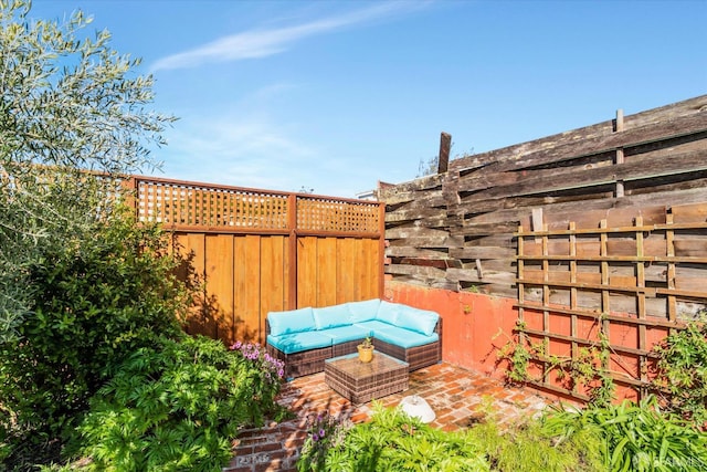 view of patio with an outdoor living space and fence