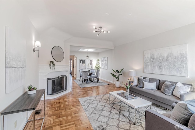 living room featuring a notable chandelier and baseboards