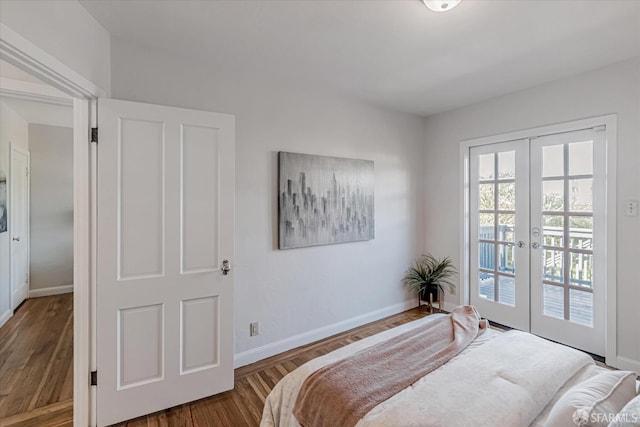 bedroom with wood finished floors, access to outside, french doors, and baseboards