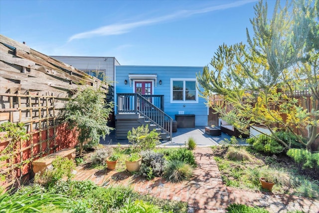 view of front of house with a patio and fence