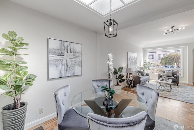 dining space featuring baseboards and wood finished floors