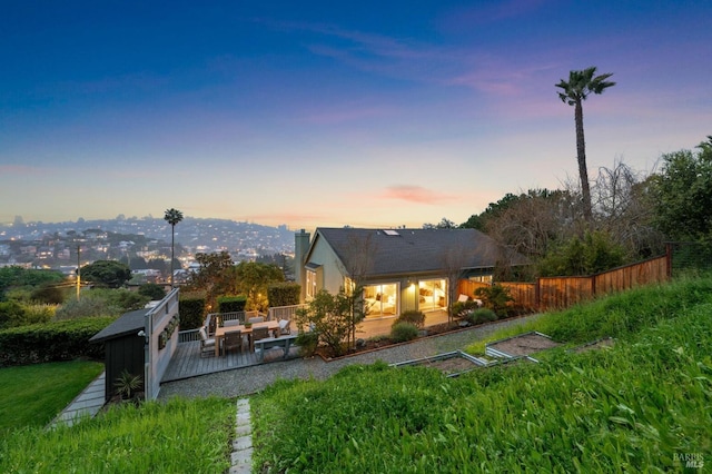 1837 Centro W St, Tiburon, CA 94920 - back of house at dusk with an outdoor hangout area, a chimney, fence, and a wooden deck