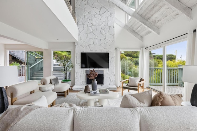 1837 Centro W St, Tiburon, CA 94920 - living room featuring a stone fireplace, beamed ceiling, high vaulted ceiling, and wood finished floors