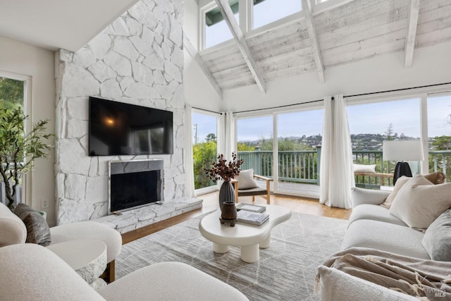 1837 Centro W St, Tiburon, CA 94920 - living room featuring a wealth of natural light, a stone fireplace, beam ceiling, and wood finished floors