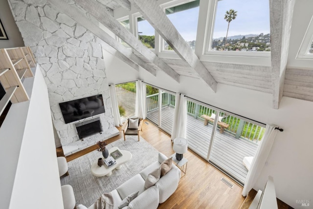 1837 Centro W St, Tiburon, CA 94920 - living room with a fireplace, a high ceiling, wood finished floors, visible vents, and beamed ceiling