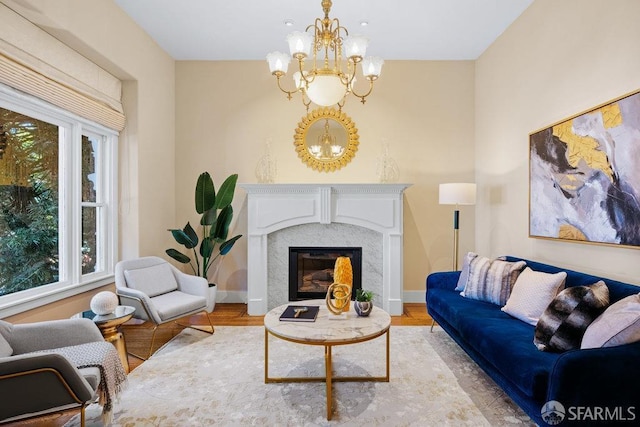 living room featuring a premium fireplace, light hardwood / wood-style floors, and a wealth of natural light