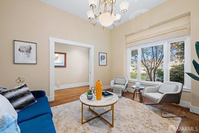 living room featuring a notable chandelier and wood-type flooring