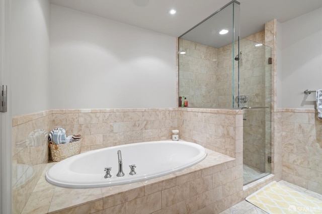 bathroom with independent shower and bath and tile patterned flooring