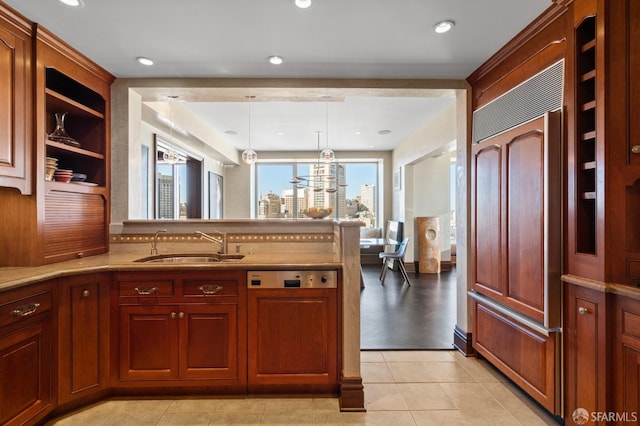 kitchen featuring light tile patterned flooring, sink, an inviting chandelier, paneled built in fridge, and pendant lighting