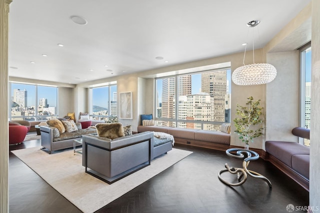 living room featuring a notable chandelier and parquet floors