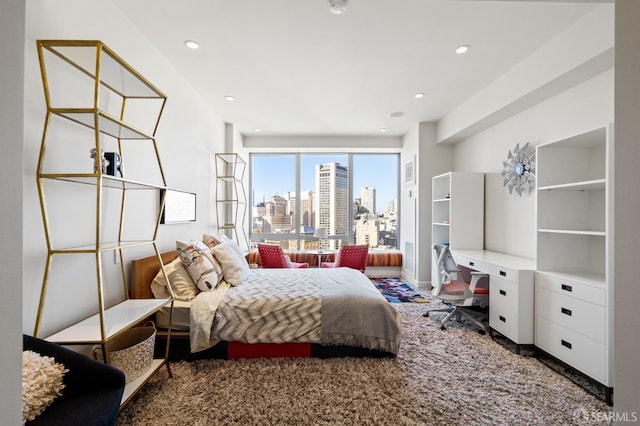 bedroom with carpet floors and built in desk