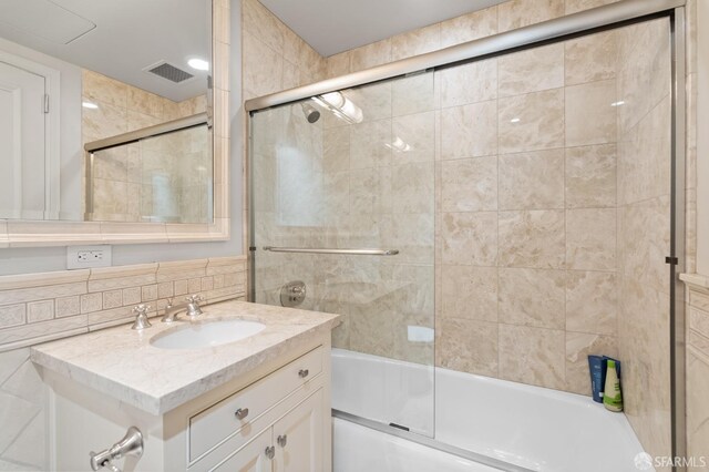 765 Market St Unit 28D, San Francisco, CA 94103 - bathroom featuring enclosed tub / shower combo, vanity, and tile walls