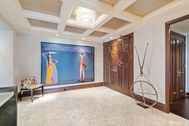 home theater with coffered ceiling, a notable chandelier, and beam ceiling