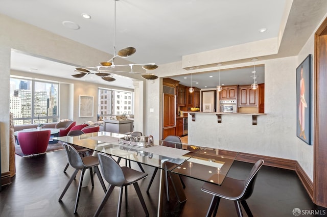 dining room featuring dark wood-type flooring and an inviting chandelier