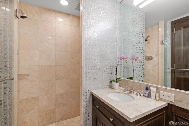 bathroom featuring vanity and a tile shower