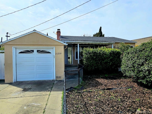 ranch-style house with stucco siding, a garage, concrete driveway, and a chimney
