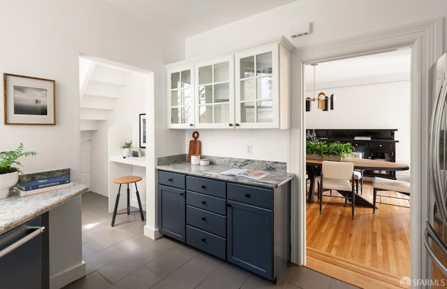 1828 Grove St, San Francisco, CA 94117 - kitchen featuring glass insert cabinets, white cabinets, freestanding refrigerator, and dark tile patterned flooring