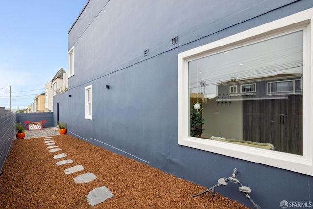 view of home's exterior featuring fence and stucco siding