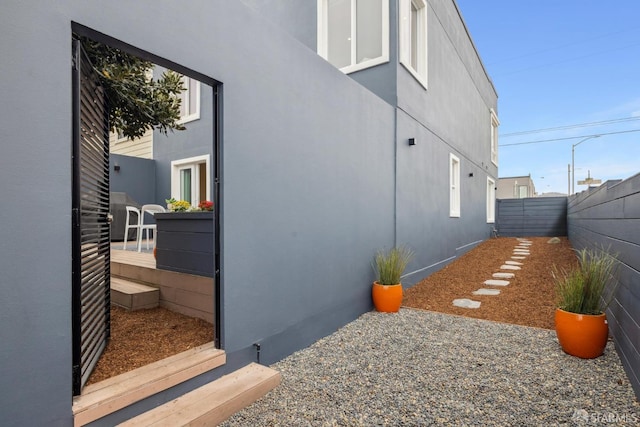 view of property exterior featuring fence and stucco siding