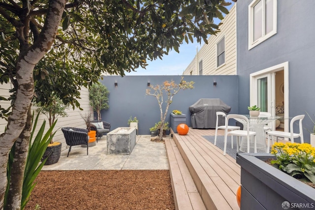 view of patio featuring a deck, an outdoor hangout area, and a grill