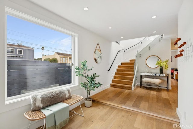 interior space featuring stairs, recessed lighting, baseboards, and wood finished floors