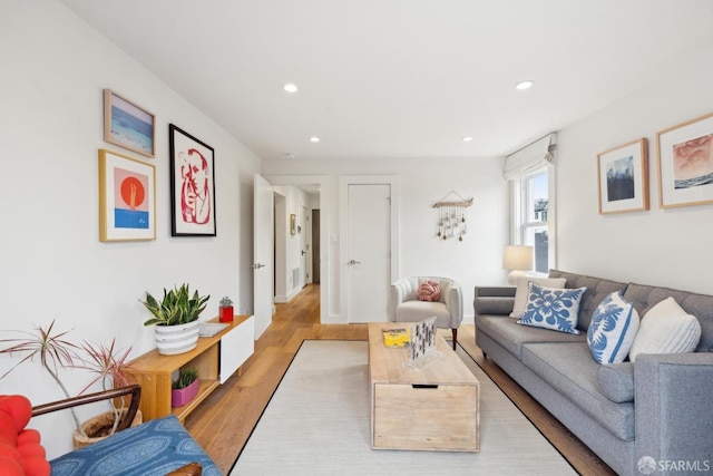 living area featuring wood finished floors and recessed lighting