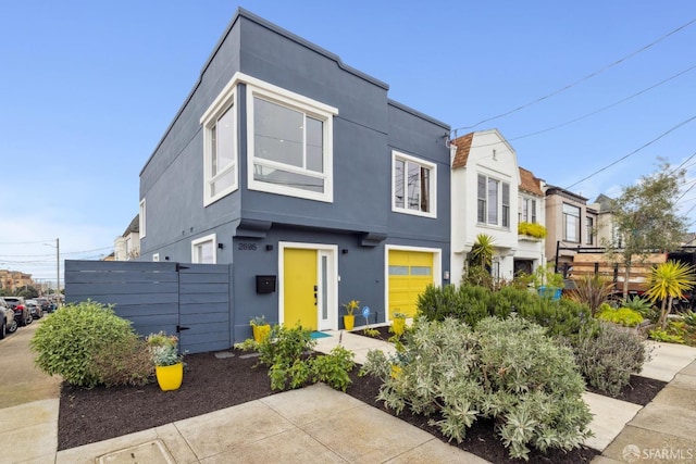 view of front of property featuring fence and stucco siding