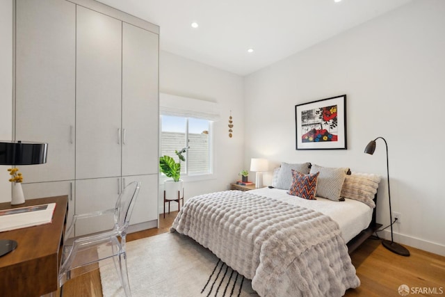 bedroom featuring recessed lighting, baseboards, and wood finished floors