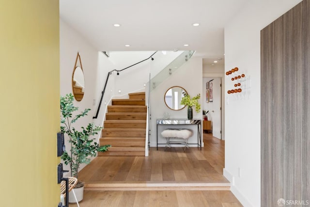 entryway featuring recessed lighting, stairway, and wood finished floors