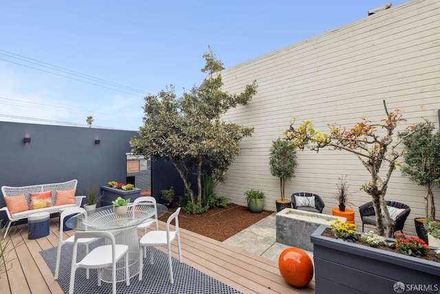 wooden terrace featuring outdoor dining space