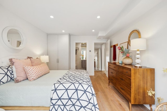 bedroom featuring a closet, recessed lighting, and light wood-style floors