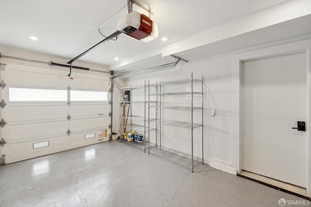 garage featuring a garage door opener and recessed lighting