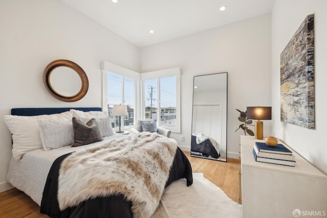 bedroom featuring light wood-type flooring, baseboards, and recessed lighting