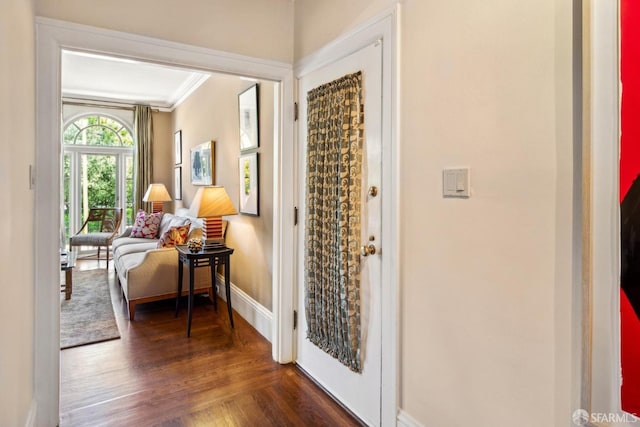 foyer entrance featuring ornamental molding and baseboards